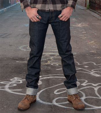 a man wearing straight leg jeans with folded cuffs and boots