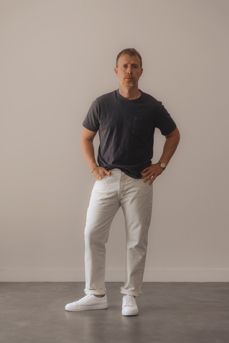 summer outfit for men with black pocket t-shirt and white levi's 501 jeans with with sneakers